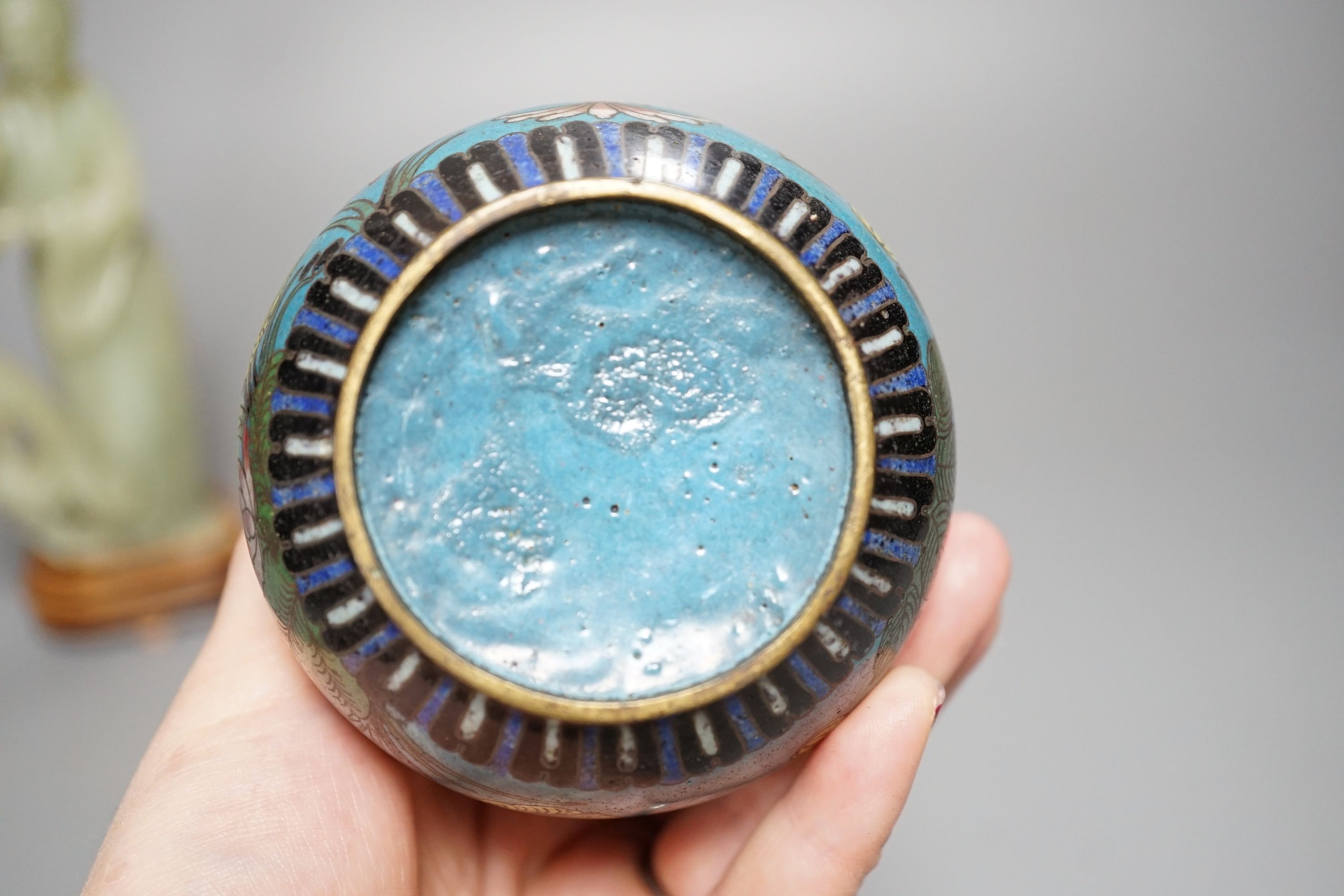 A small enamelled cloisonné vase, 10cm, together with a carved bowenite jade figure, on wood plinth and glazed ceramic brush pot